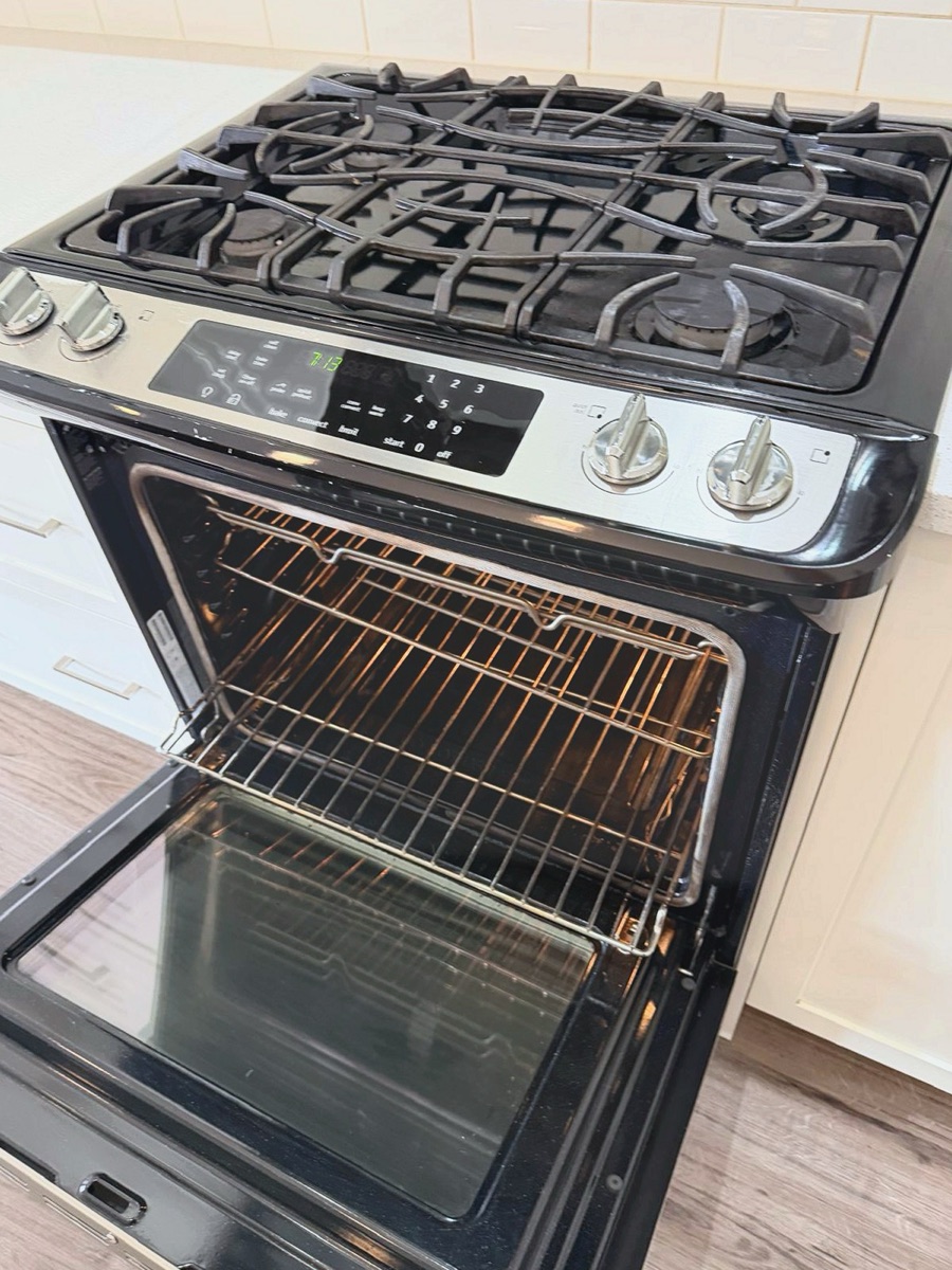 Gas stovetop and open oven with clean racks and glass after a NeatNow clean