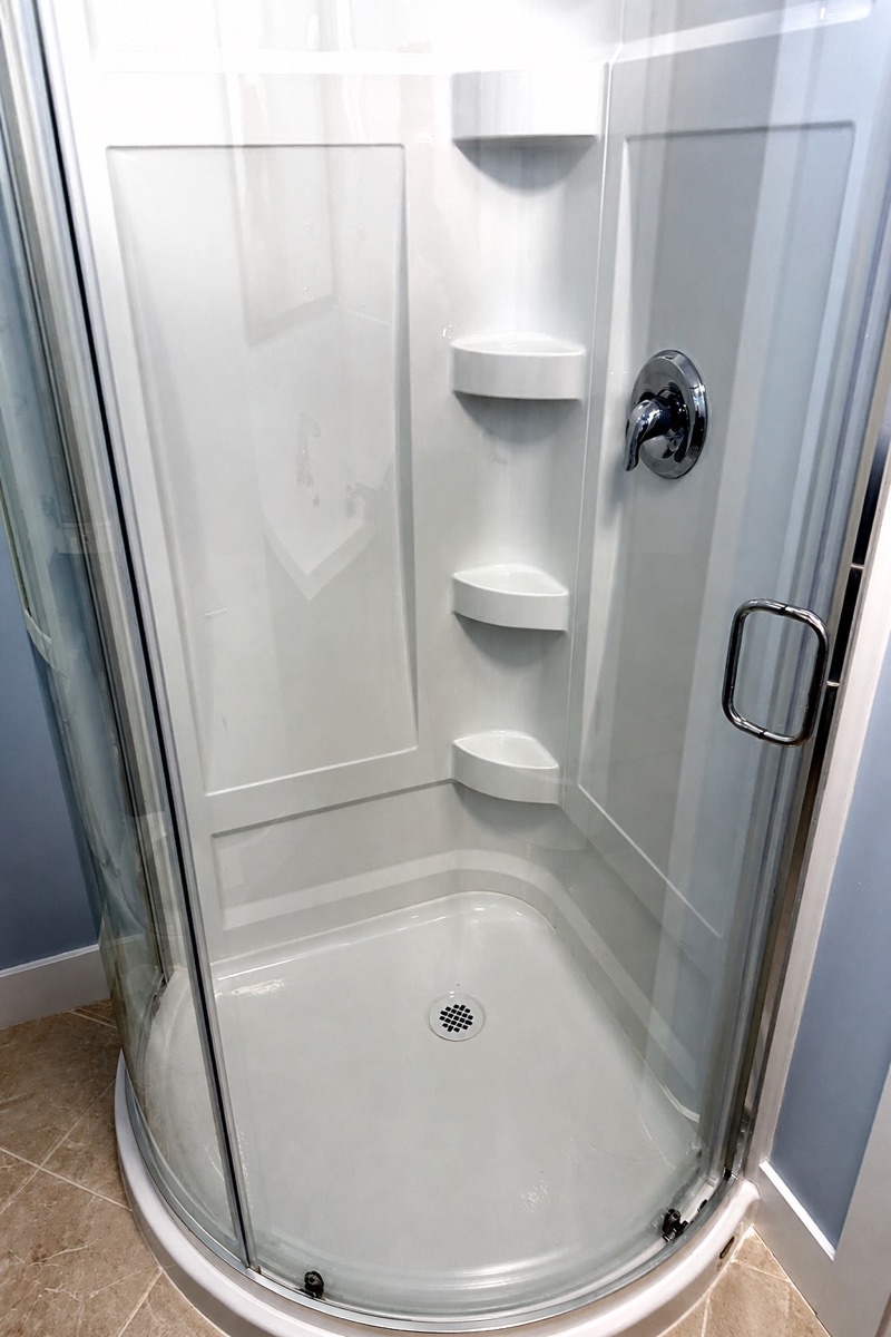 Corner shower stall with glass door cleaned and polished after a NeatNow clean