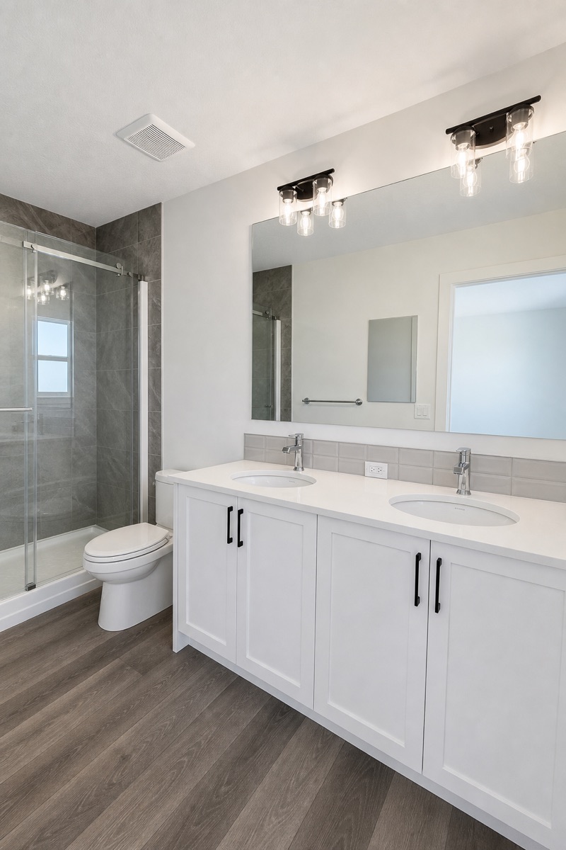 Double vanity, shower, and bathroom floors after a NeatNow clean