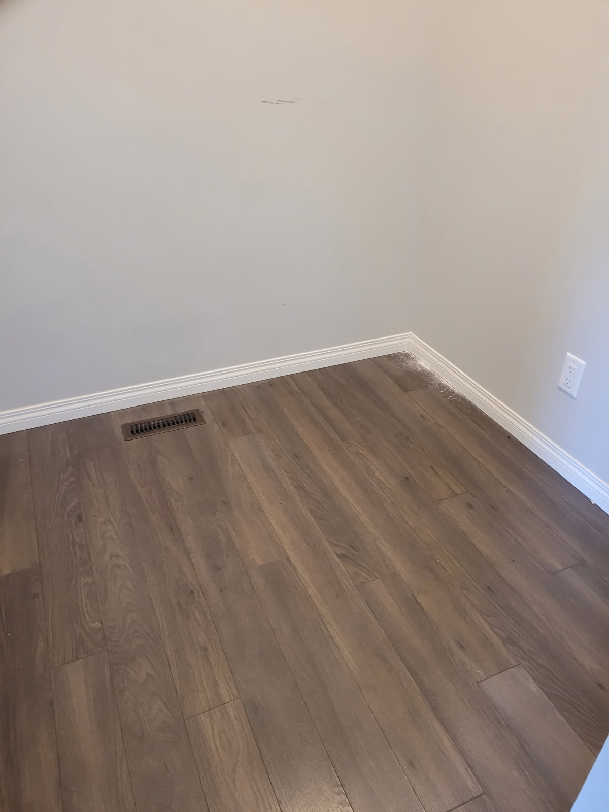 Clean baseboards and hardwood floors detail
