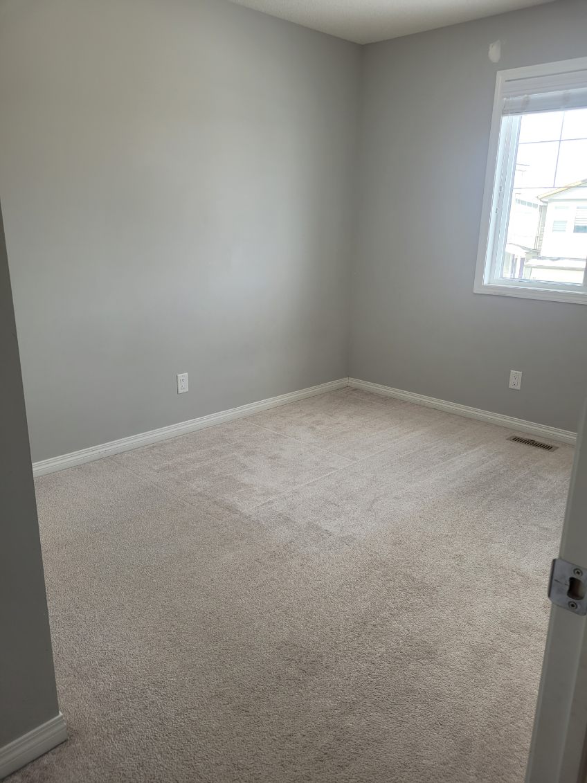 Vacuumed carpet in a bedroom cleaned for a move