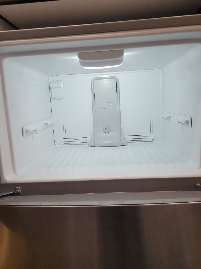 Cleaned freezer compartment, empty and wiped down