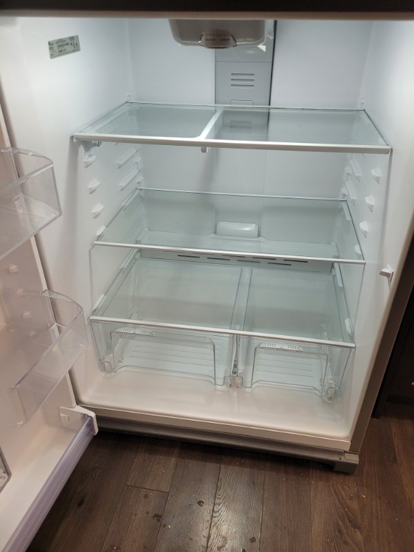 Empty fridge interior cleaned to the shelves and drawers