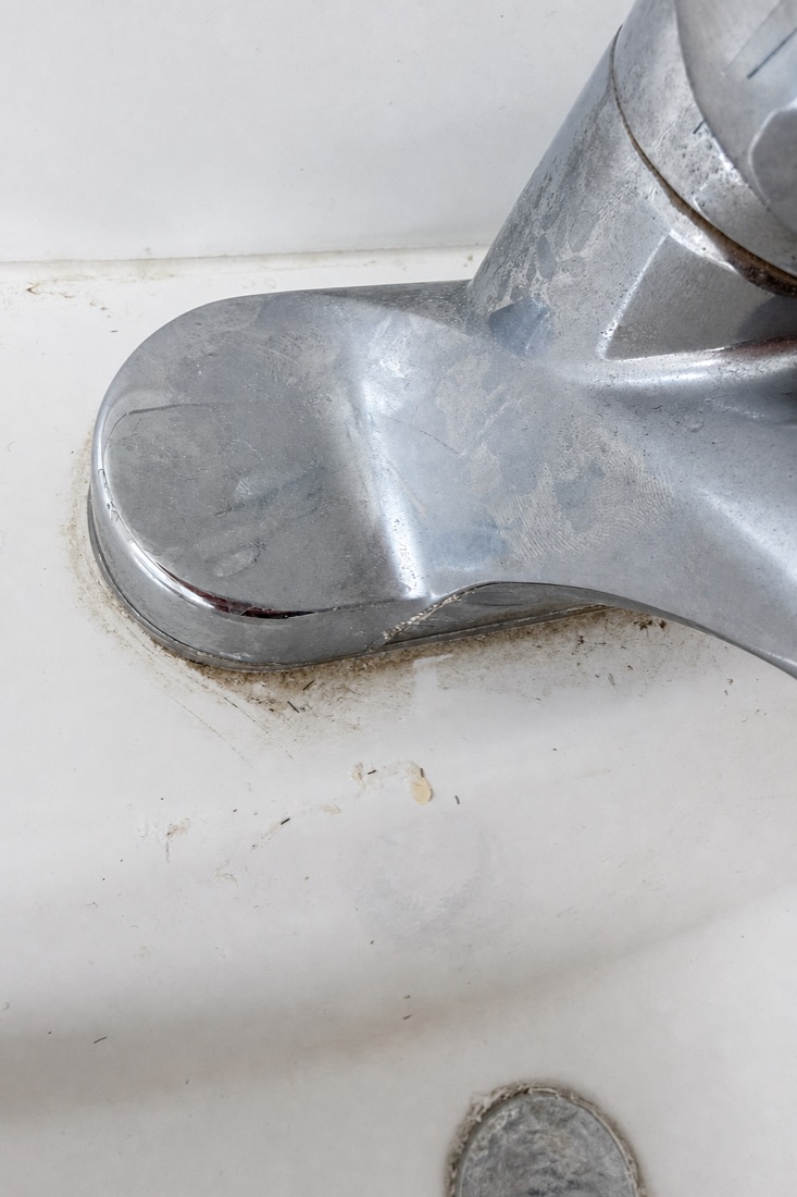Before photo of a faucet with Calgary hard-water scale, before a NeatNow clean