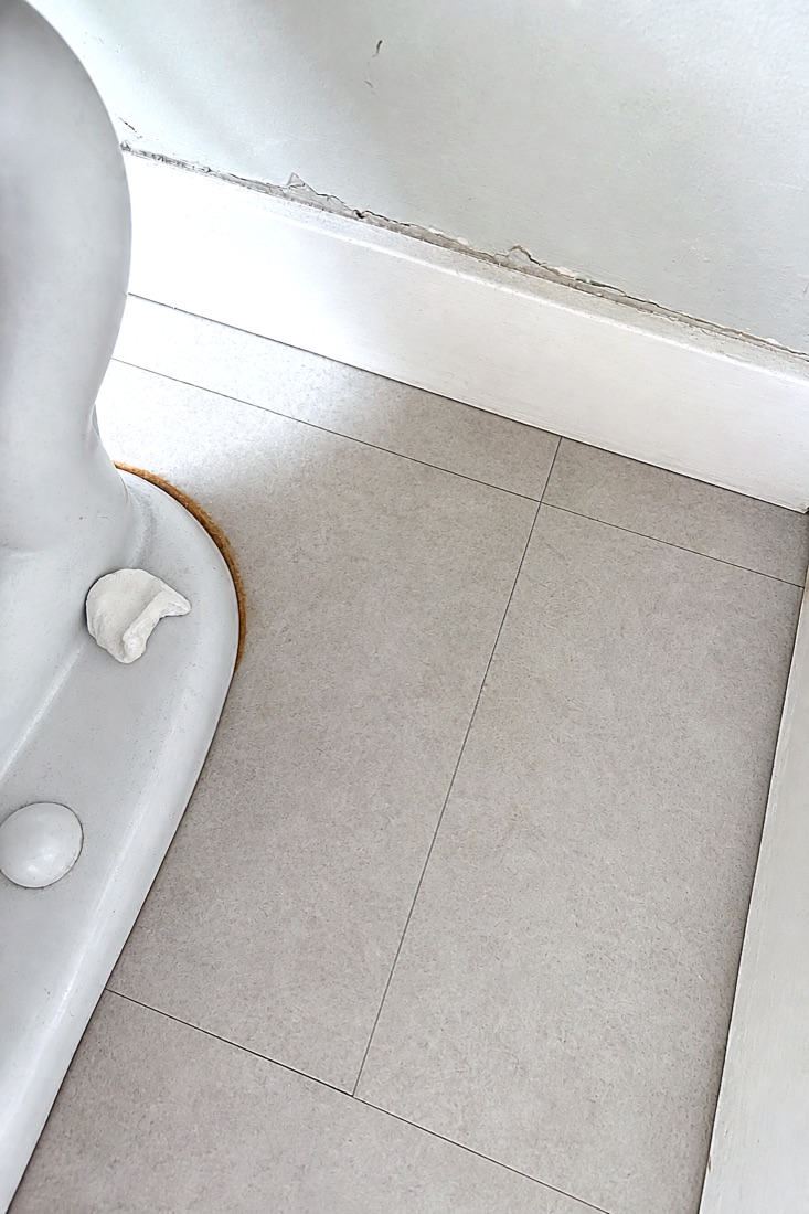 After photo of the same bathroom tile floor, grime removed and surface clear, cleaned by NeatNow in Calgary