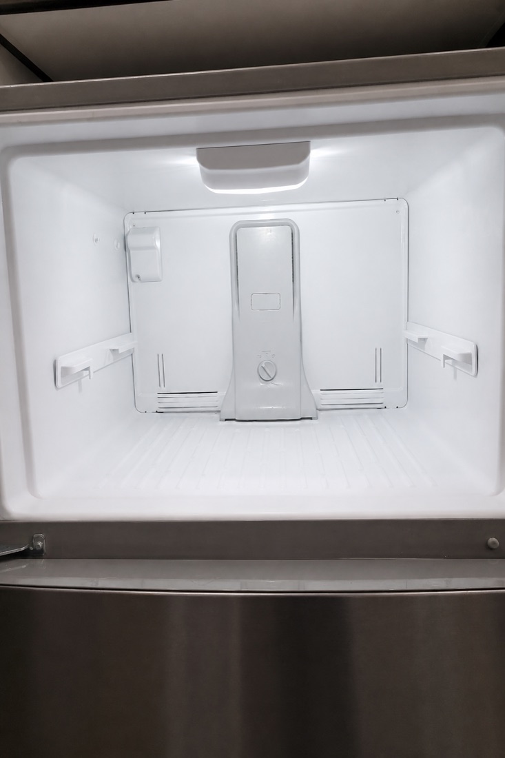 After photo of the same freezer interior, defrosted and wiped, cleaned by NeatNow in Calgary