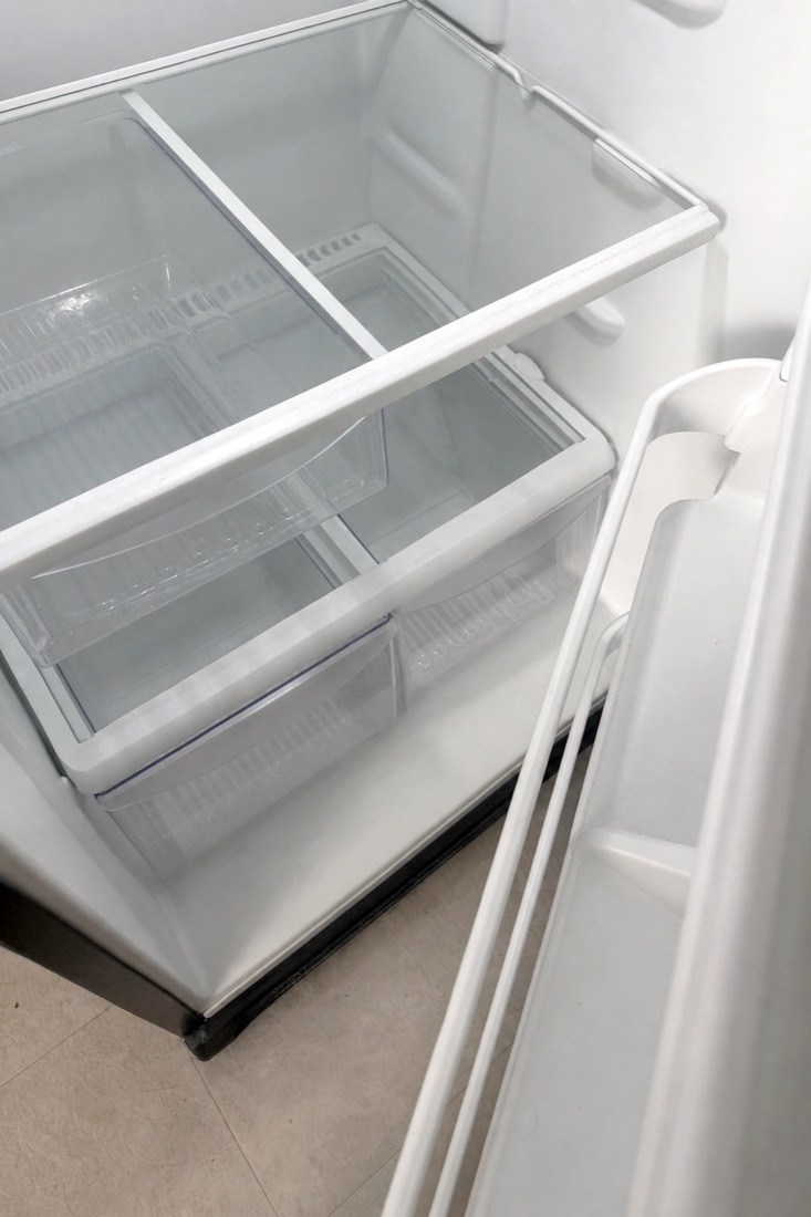 After photo of a refrigerator interior, shelves wiped clean and clear, cleaned by NeatNow in Calgary