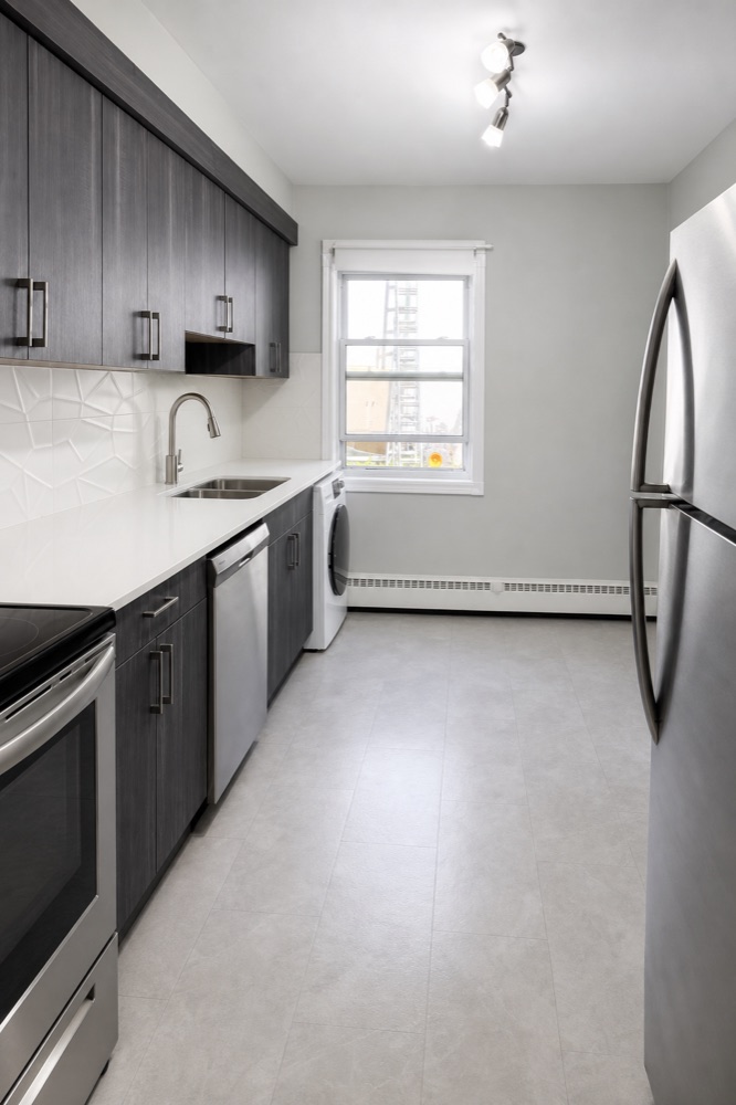 Finished galley kitchen with clean counters and floor after a NeatNow clean in Calgary