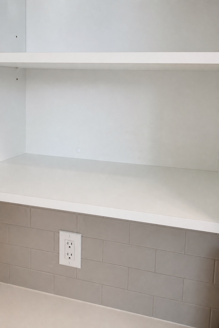 After photo of the same shelf wiped clear of crumbs and rings, cleaned by NeatNow in Calgary