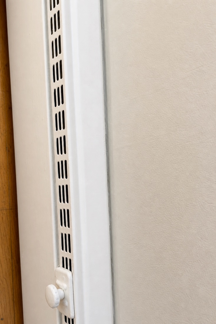After photo of the same heating vent wiped back to white, cleaned by NeatNow in Calgary
